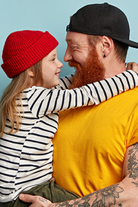 Caucasian father holding daughter