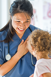 Asian nursing professional with child